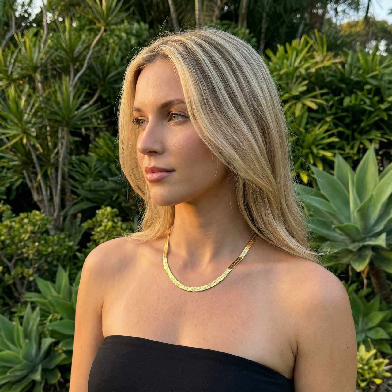 The Golden Statement necklace by Brother & Sisters showcased on a model in nature, highlighting its elegant design.