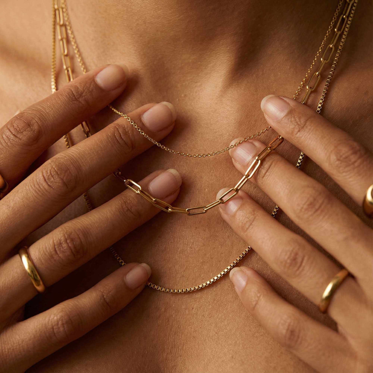 Saona Triple Layer Necklace by Brother & Sisters featuring three gold chains of varying lengths.