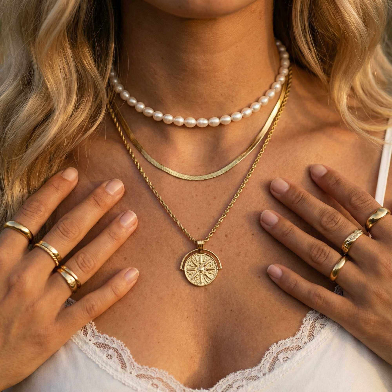 Golden Sun Necklace worn with layers of delicate chains and rings, radiating warmth and elegance by Brother & Sisters.