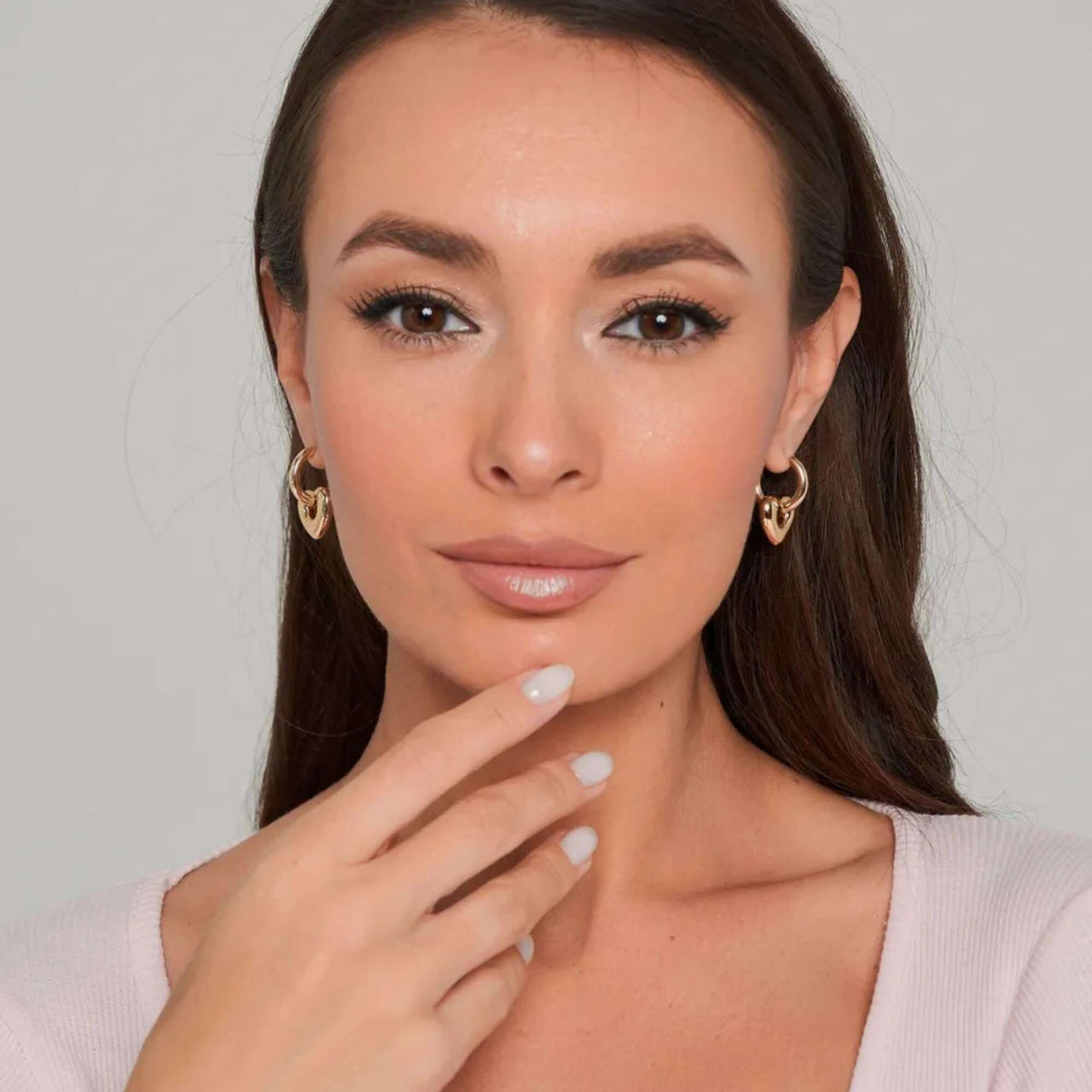 Aurora Heart Hoops worn by model, showcasing elegance and feminine style by Brother & Sisters.