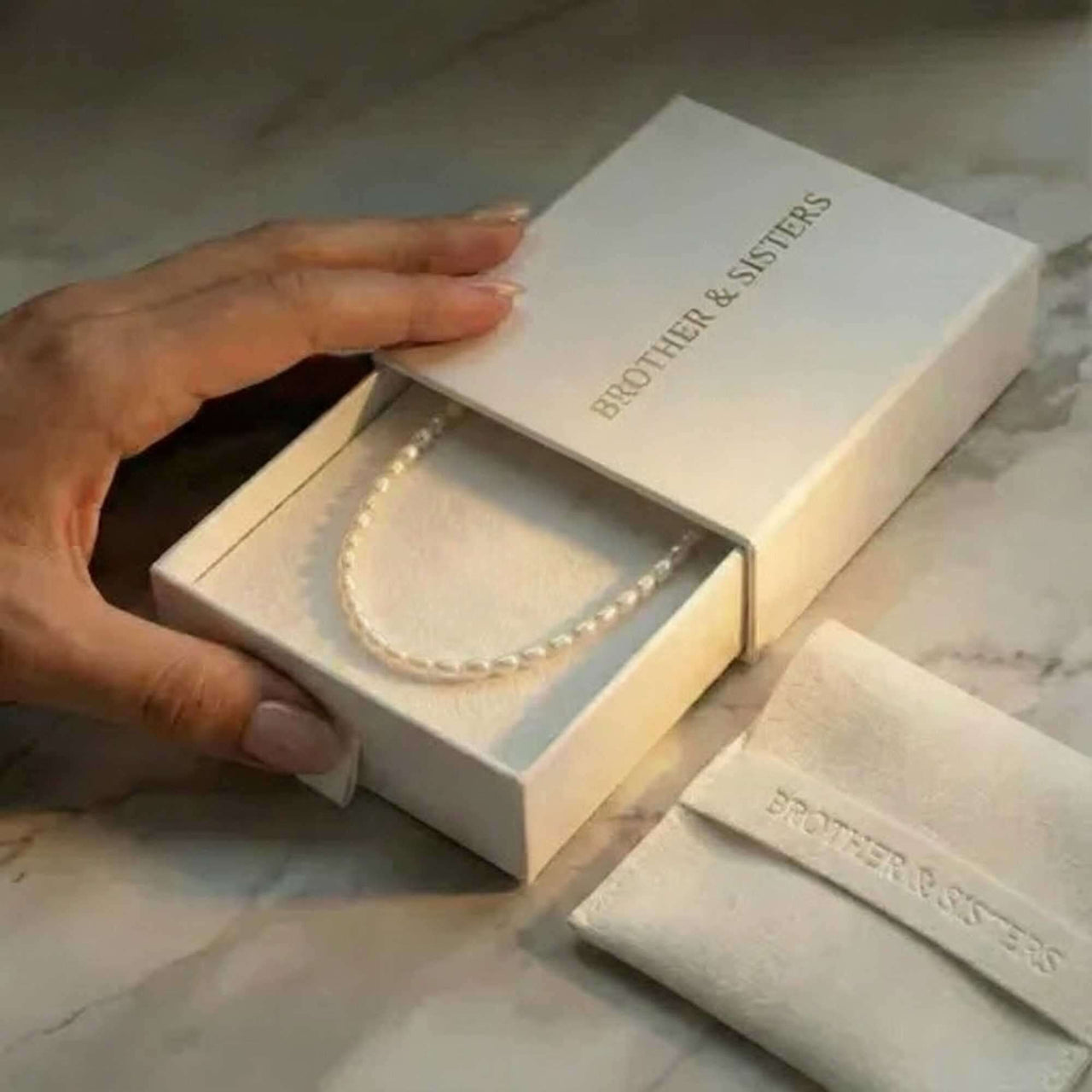 Freshwater pearl choker in B&S gift box on marble — luxury packaging for anniversary or wedding gift
