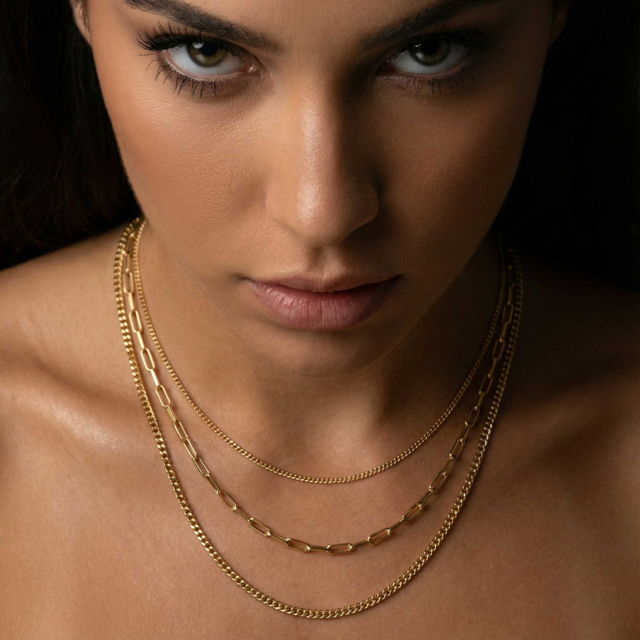 Saona Triple Layer Necklace featuring three gold chains of varying lengths by Brother & Sisters.