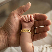 Thumbnail for Infant Bracelet on baby's wrist with the name 'Sofia', held by a parent's hand, by Brother & Sisters.