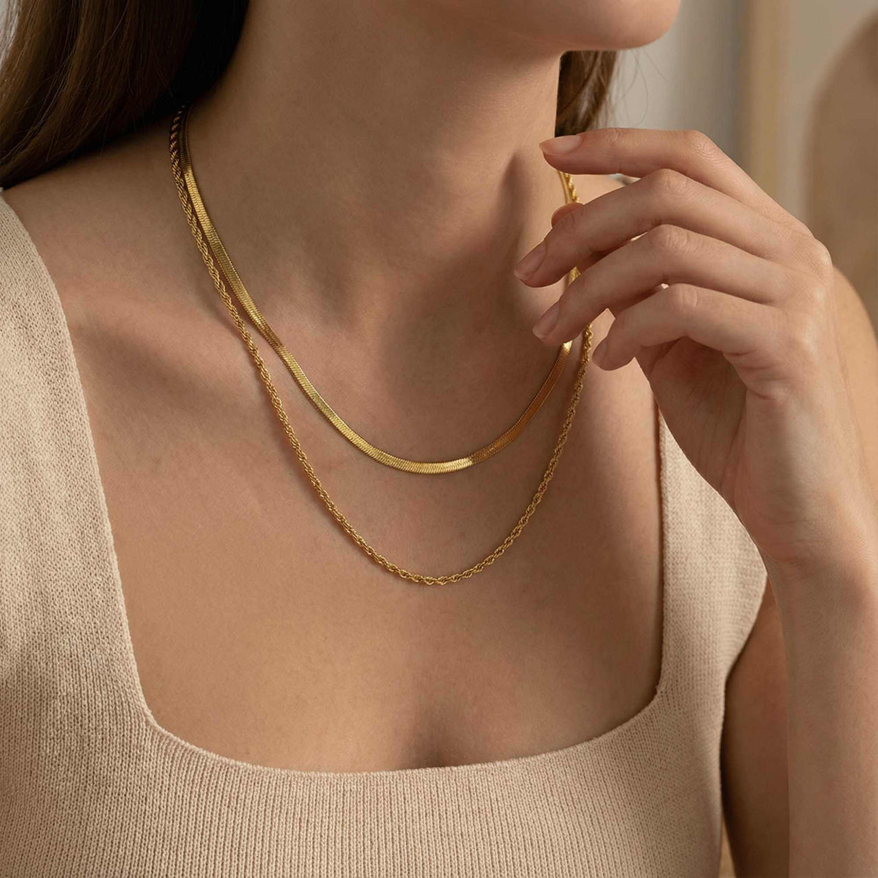 The Double Luxe layered necklace by Brother & Sisters features a sleek herringbone and delicate rope chain.