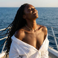 Thumbnail for White Beaded Choker worn by model on a boat with ocean background, featuring gold accents and tiny white enamel beads, Brother & Sisters