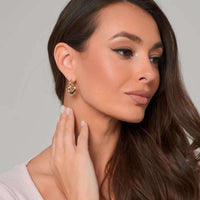 Thumbnail for Woman wearing Aurora Heart Hoops gold earrings by Brother & Sisters, showcasing elegance and femininity.