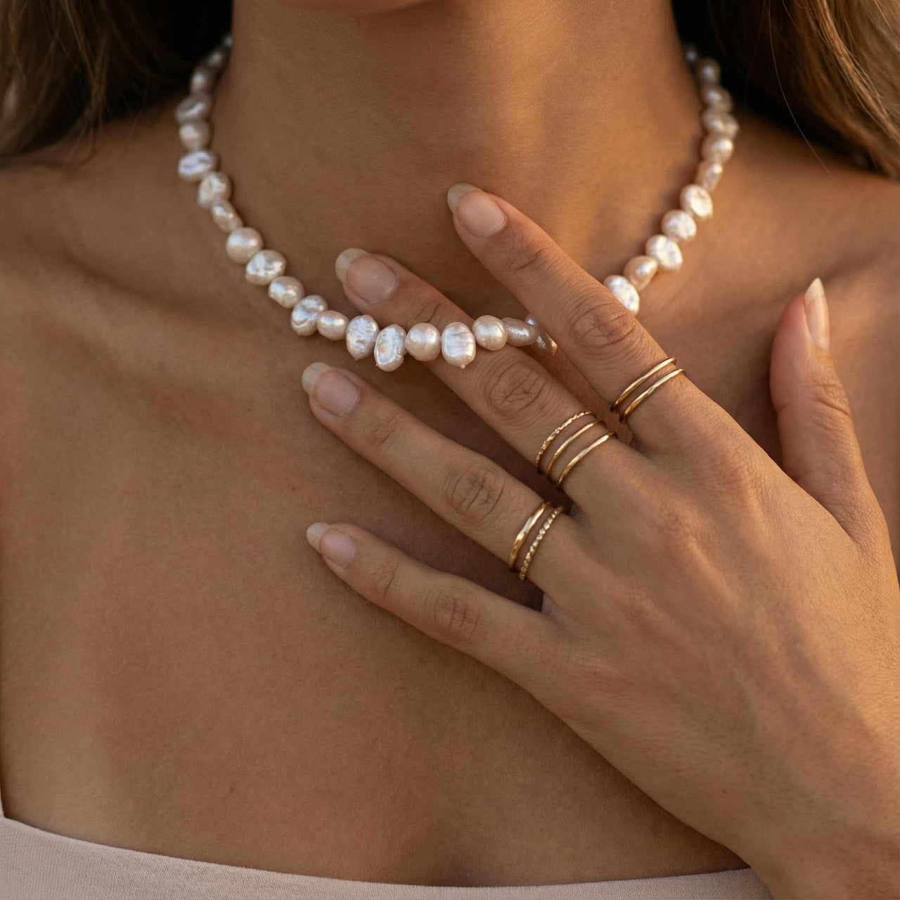 Sunseeker Pearl Choker showcasing irregular baroque pearls on a golden chain by Brother & Sisters.