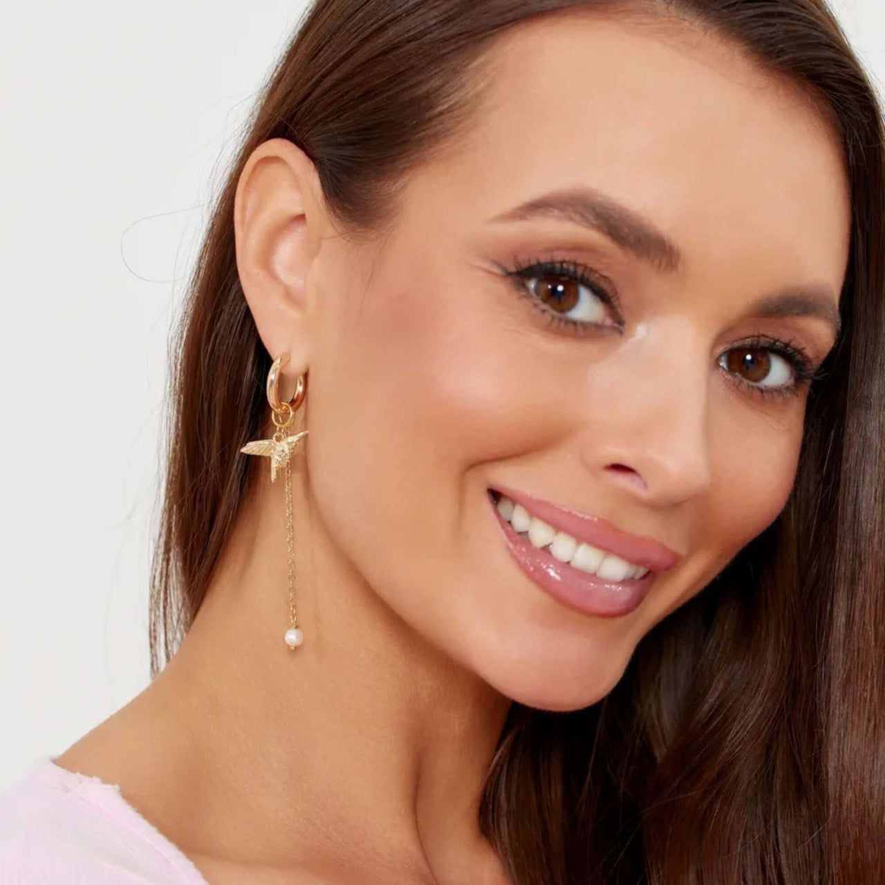Celeste Charm Hoops featuring a delicate hummingbird and faux pearl, crafted by Brother & Sisters.