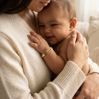 Thumbnail for Infant Bracelet on baby, personalized keepsake by Brother & Sisters, capturing a tender moment.