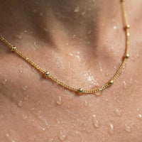 Thumbnail for Julia Beaded Chain Necklace with tiny golden beads, showcasing its elegance and shine. By Brother & Sisters.