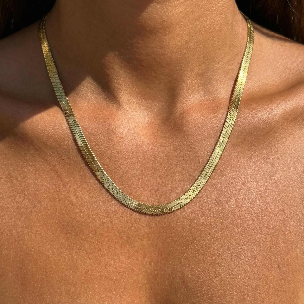 The Golden Statement necklace by Brother & Sisters; luxurious herringbone design, sleek shimmer, versatile style.