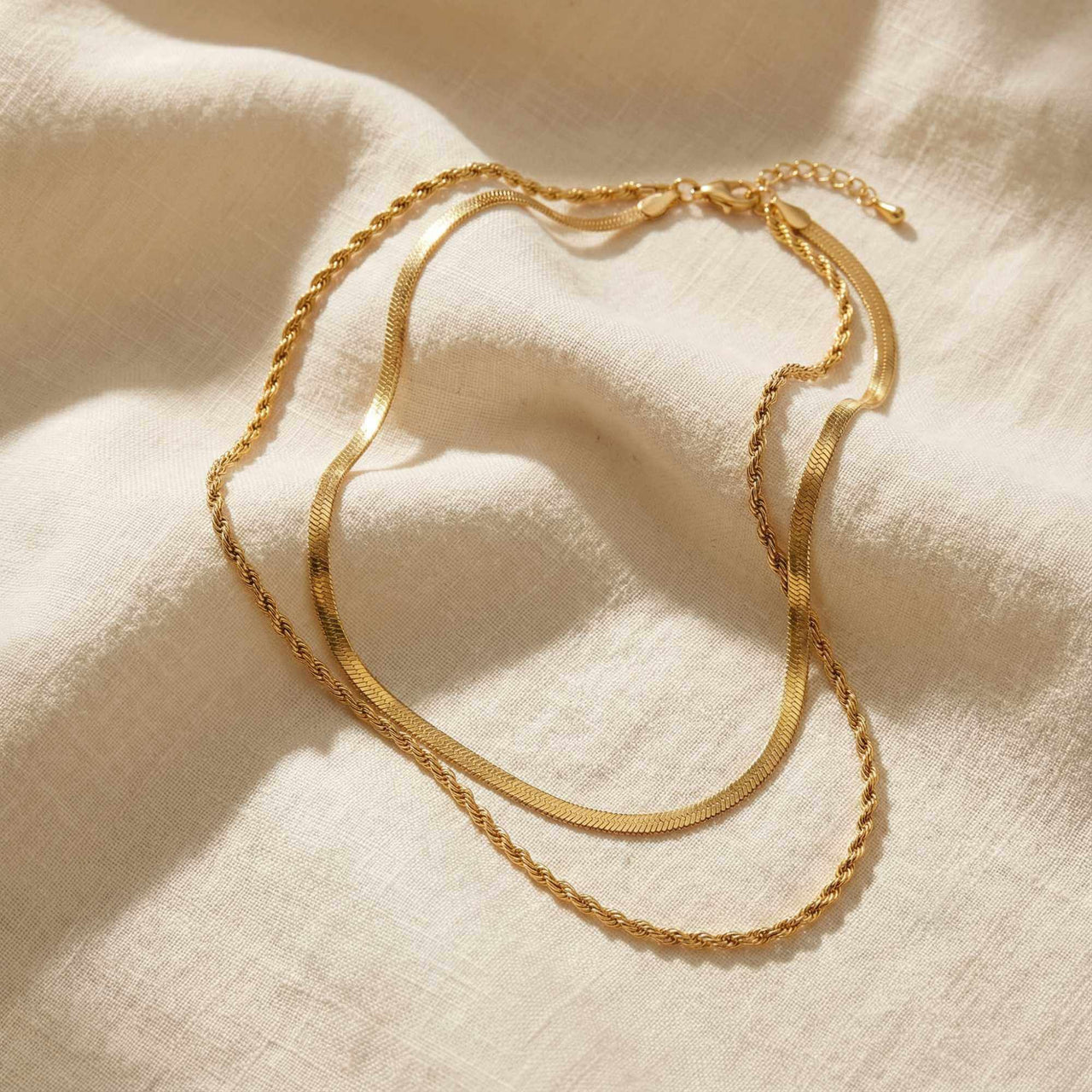 The Double Luxe double-chain necklace by Brother & Sisters featuring a sleek herringbone and delicate rope chain.