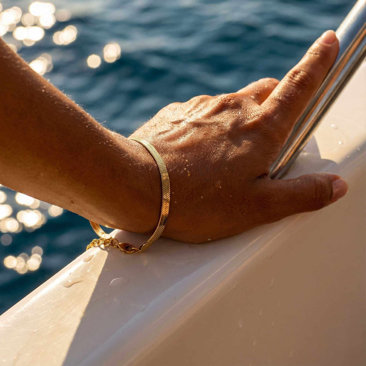 Kauai Herringbone Bracelet on a hand, showcasing its sleek design and liquid-gold shimmer by Brother & Sisters.