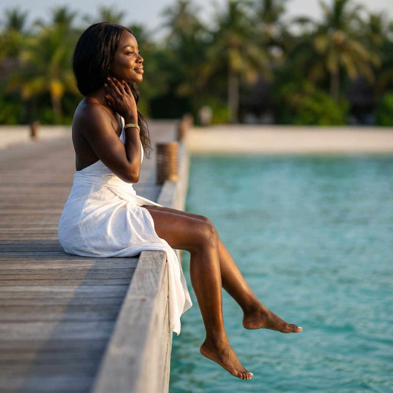 Woman enjoying the view by the water while wearing the Sifnos Woven Bracelet by Brother & Sisters.