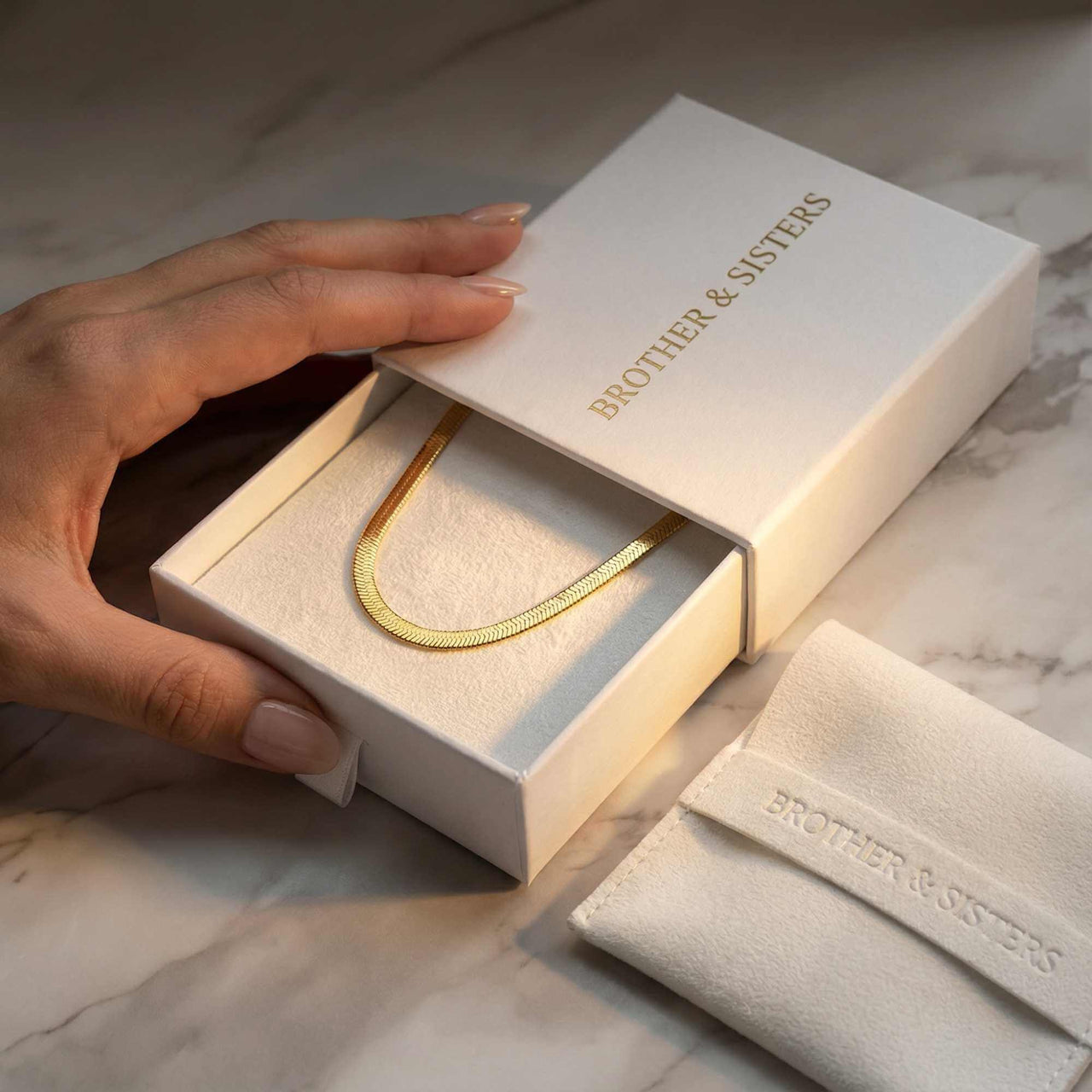 The Golden Statement necklace by Brother & Sisters in elegant packaging with herringbone design.