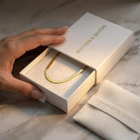Thumbnail for The Golden Statement necklace by Brother & Sisters in elegant packaging with herringbone design.