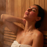 Thumbnail for Woman enjoying a steam sauna wearing a Paperclip Chain Bracelet by Brother & Sisters, showcasing elegant design and style.