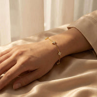 Thumbnail for Crystal Flower Bracelet featuring five sparkling crystal flowers by Brother & Sisters on a delicate gold chain.