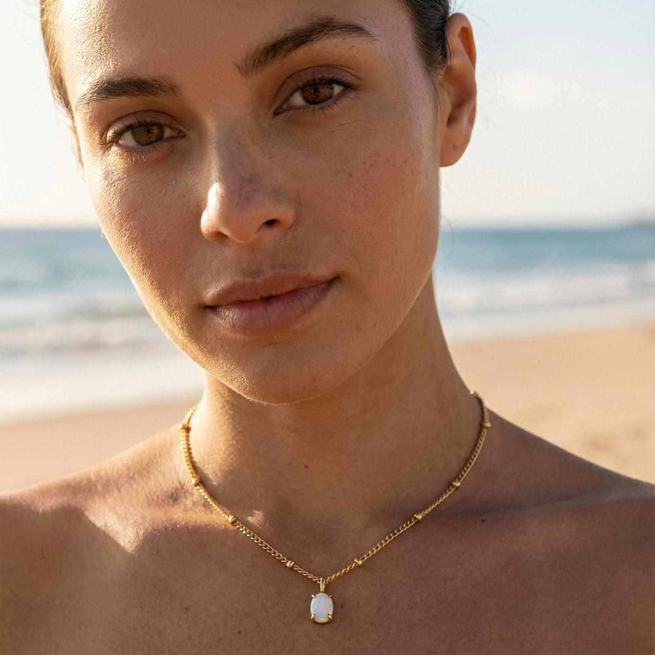 Opal Pendant Necklace by Brother & Sisters featuring AAA-grade opal in gold prongs on a delicate chain.