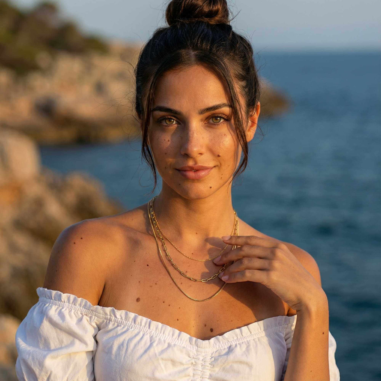 Saona Triple Layer Necklace worn by a woman, featuring three gold chains, by Brother & Sisters, styled effortlessly.