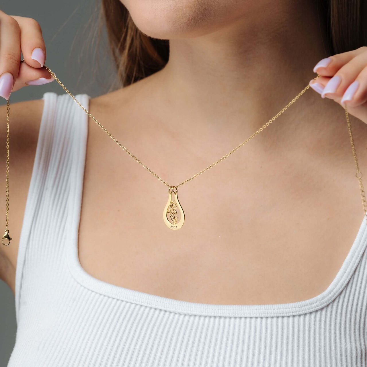 Woman wearing Birth Flower Name Necklace by Brother & Sisters, showcasing personal elegance and style.