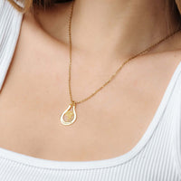 Thumbnail for Birth Flower Name Necklace from Brother & Sisters showcasing a delicate gold pendant worn on a woman's neck.