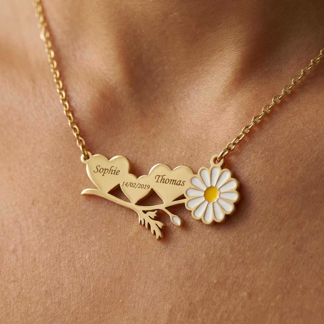 Daisy Name Necklace featuring engraved hearts with names Sophie and Thomas, delicate enamel daisy by Brother & Sisters.