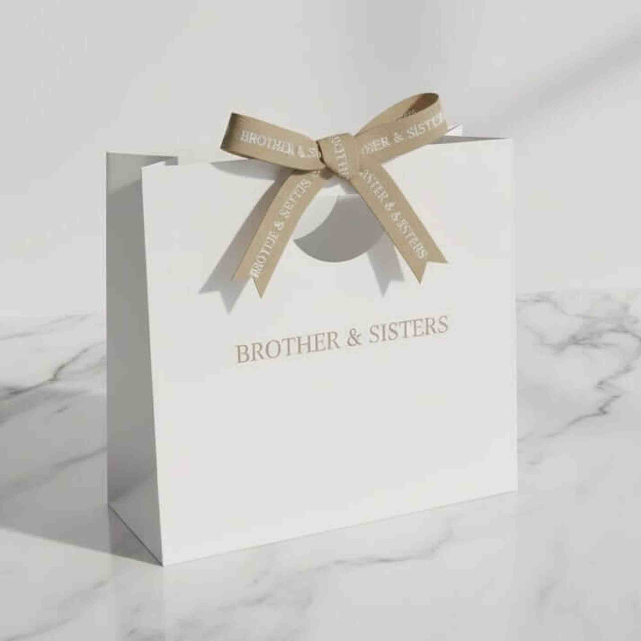 Gift Bag by Brother & Sisters featuring elegant design and refined ribbon, perfect for impressive gifting.