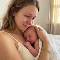Thumbnail for Emotional moment of a mother holding her newborn baby, showcasing love and connection.
