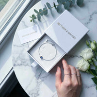 Thumbnail for Photo Projection Bracelet by Brother & Sisters in elegant box with greenery and roses.