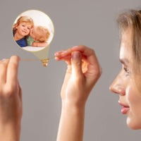 Thumbnail for Woman holding the Angel Photo Bracelet featuring a personalized photo of loved ones, designed by Brother & Sisters.