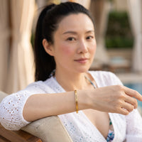 Thumbnail for Carpe Diem bracelet in gold worn during a relaxed moment | SKU: cp-g