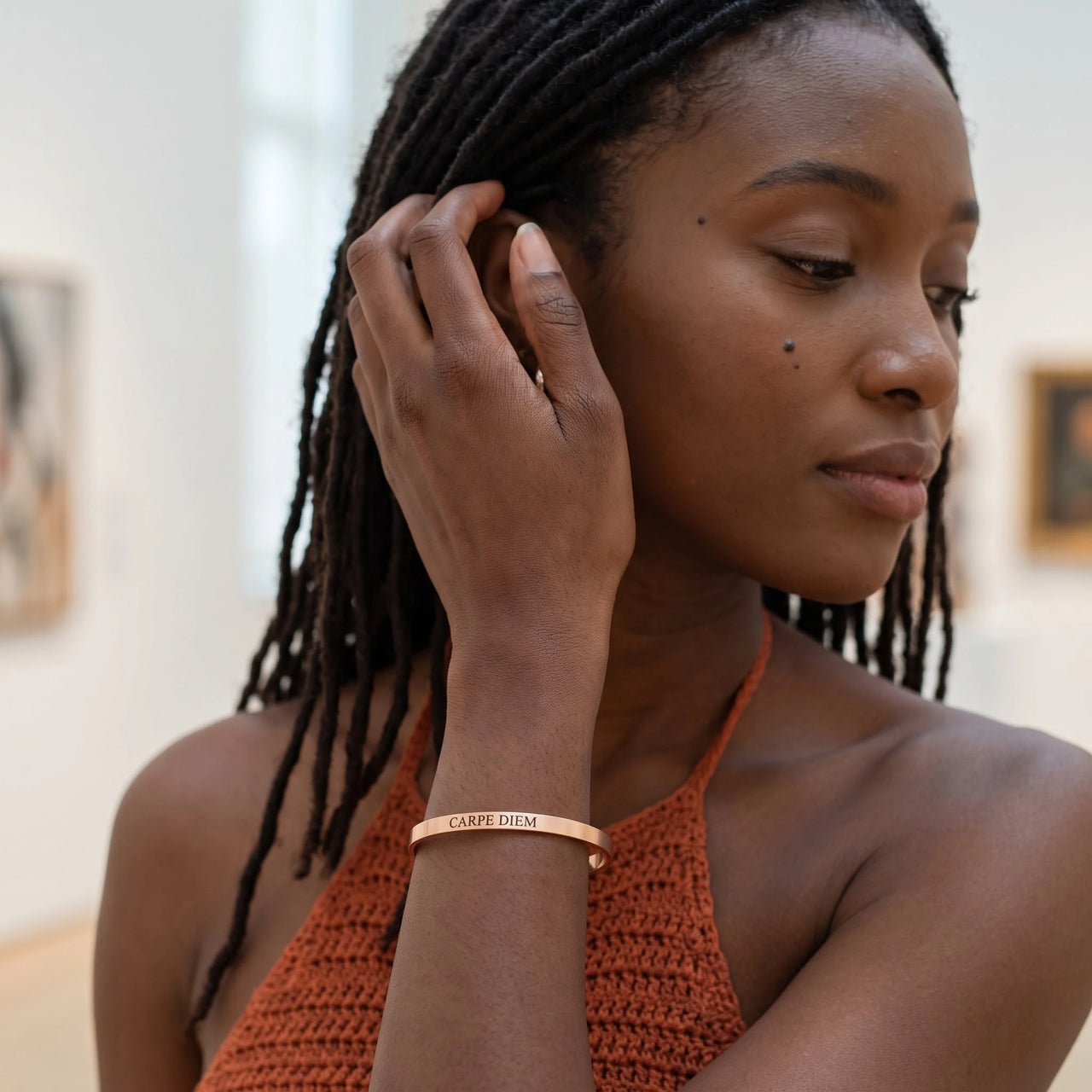 Woman gently touching her Carpe Diem bracelet in rose gold | SKU: cp-rg