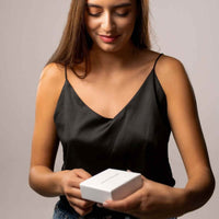Thumbnail for Double Heart Photo Necklace gift box being opened by a woman, showcasing the unique design by Brother & Sisters.