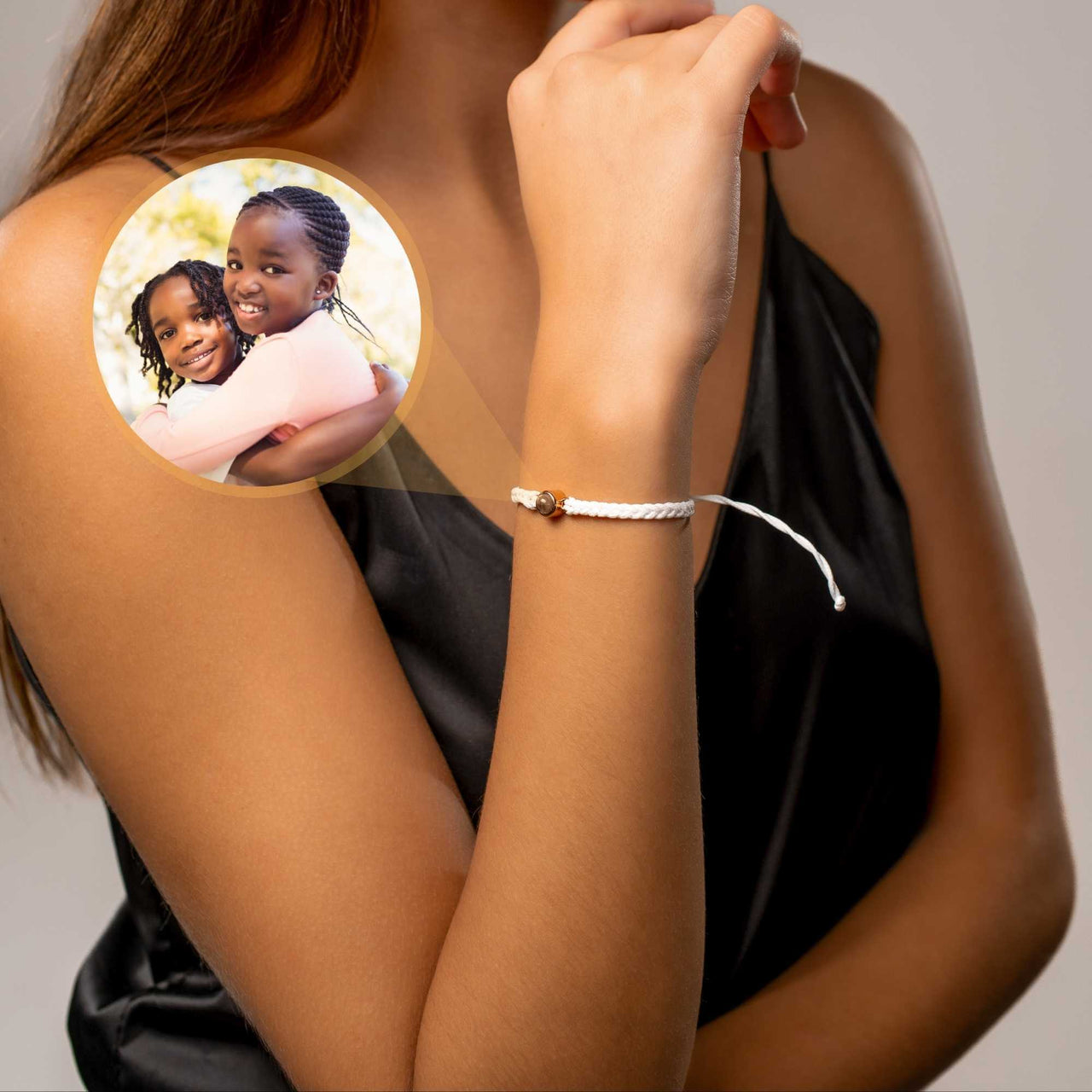 White Photo Bracelet on a woman's wrist featuring a personalized photo pendant, by Brother & Sisters.