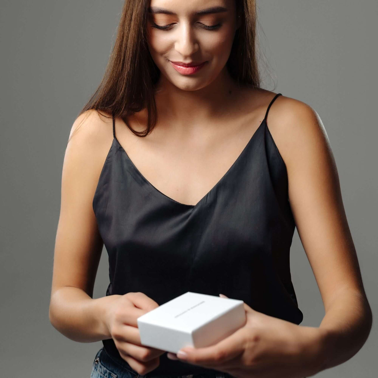 Woman unboxing the Sunflower Photo Necklace by Brother & Sisters, showcasing the elegant design and gift-ready packaging.