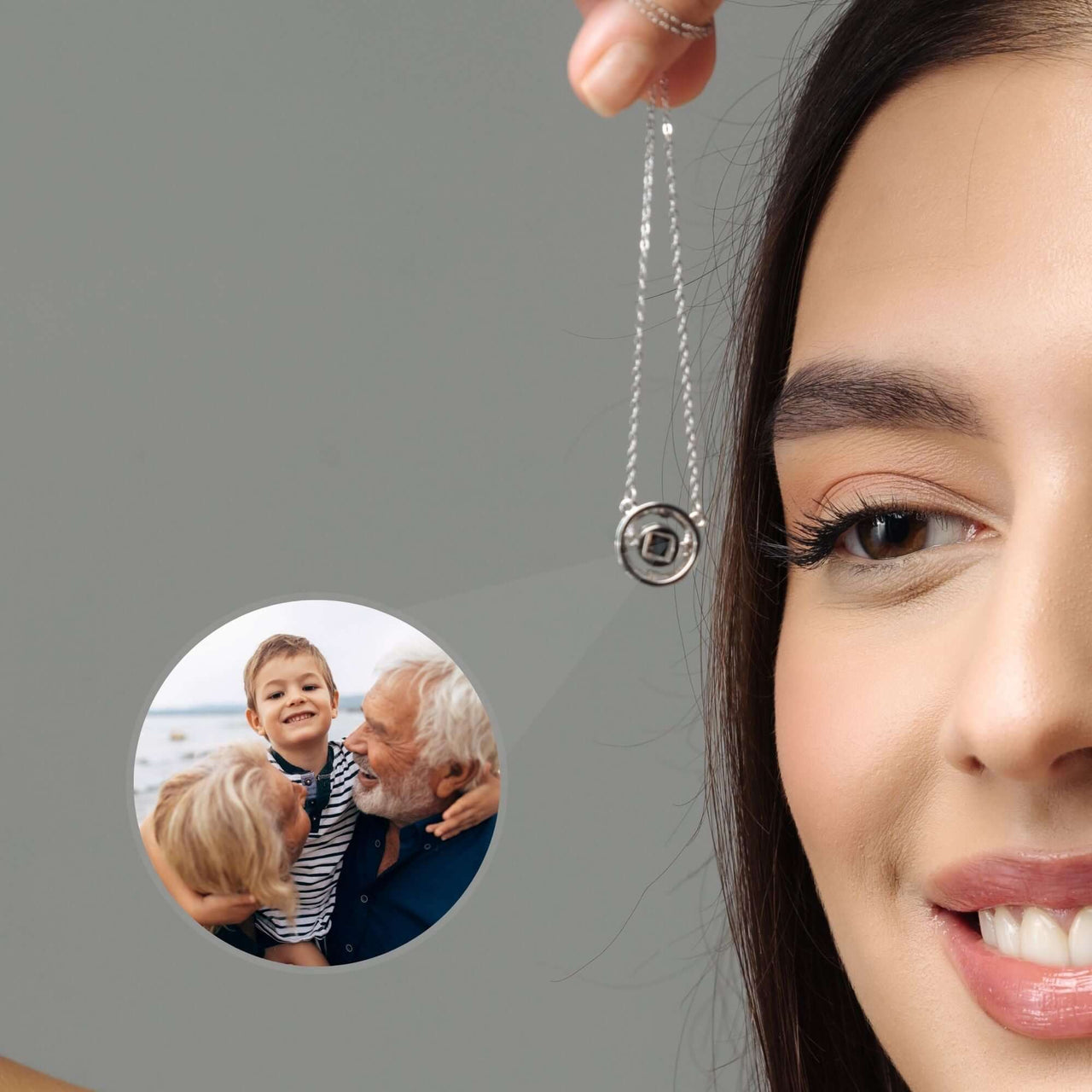 Circular Photo Necklace held by a woman, showcasing a custom photo projection of loved ones inside the pendant, by Brother & Sisters.