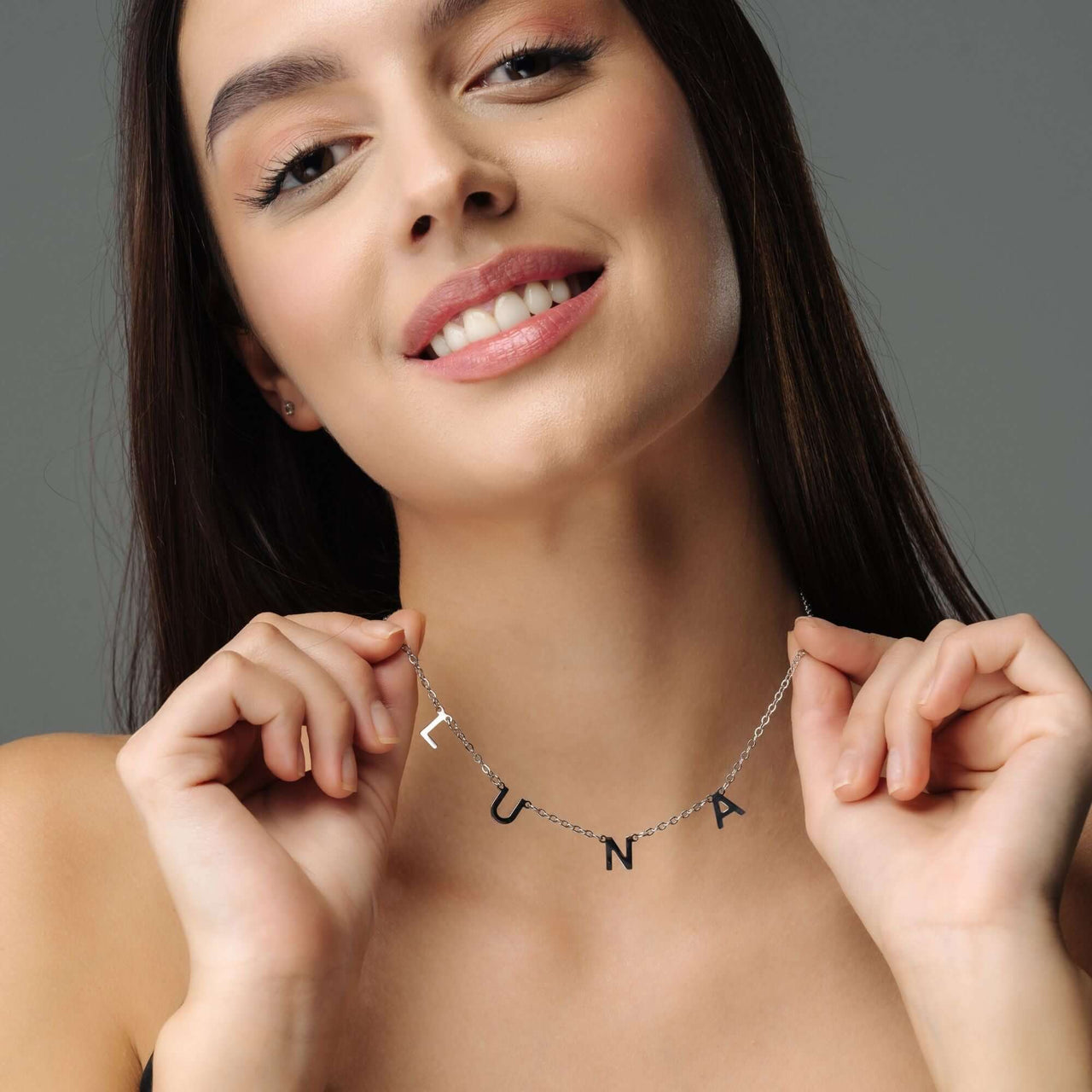 Classic Name Necklace by Brother & Sisters worn by model, showcasing the name LUNA in high-quality titanium steel.