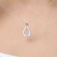 Thumbnail for Birth Flower Name Necklace by Brother & Sisters featuring a silver pendant with the name Irene and a flower design.