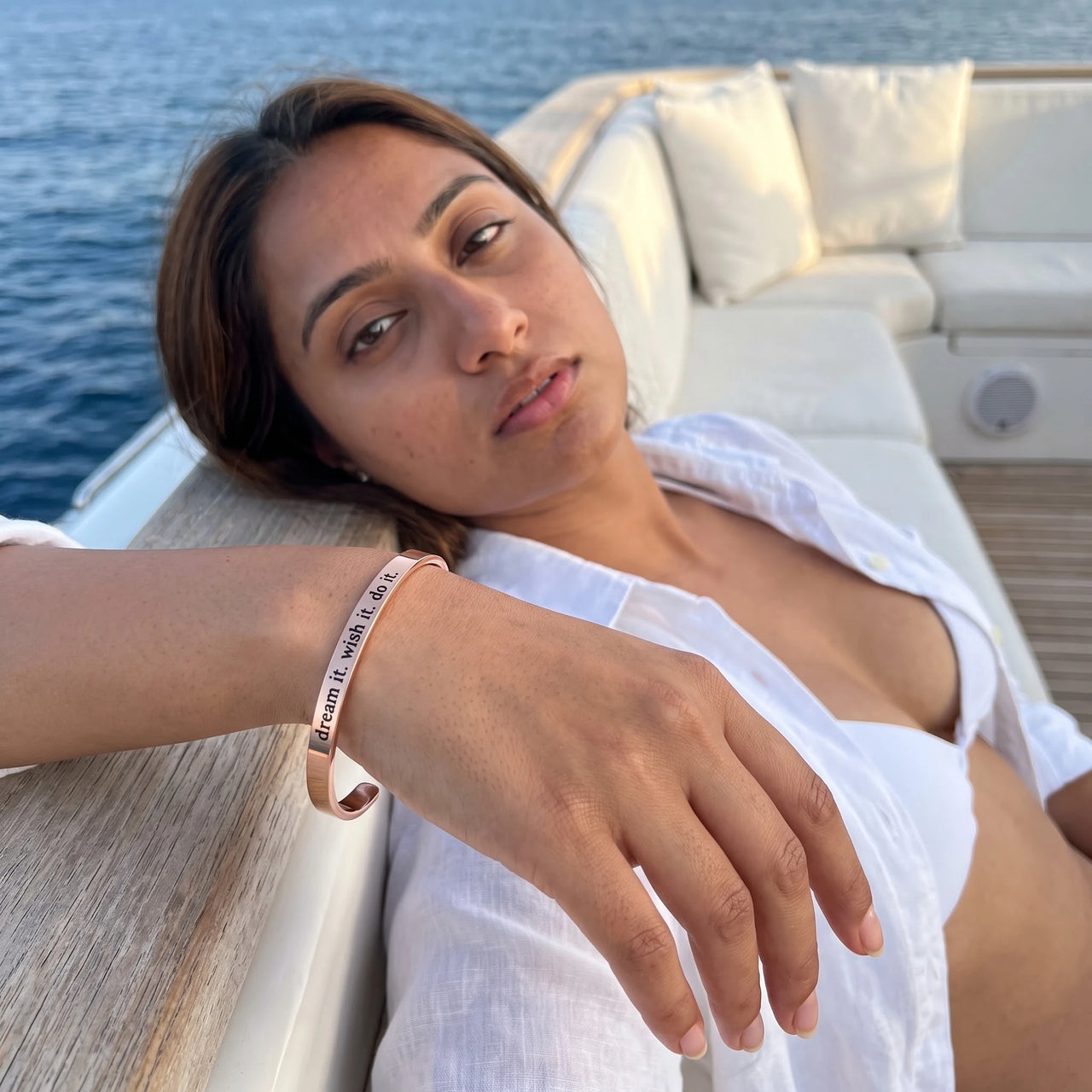 Woman on a yacht wearing the rose gold engraved cuff bracelet | SKU: 4214557-imitation-rhodium-plated