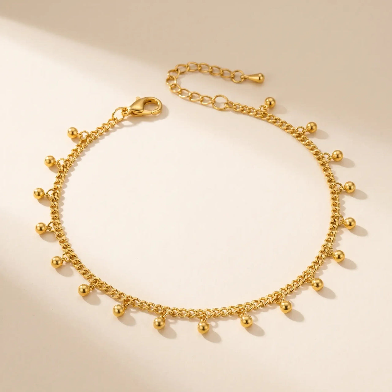 Drop Bead Anklet by Brother & Sisters, featuring shimmering gold beads on a dainty chain, perfect for summer outfits.