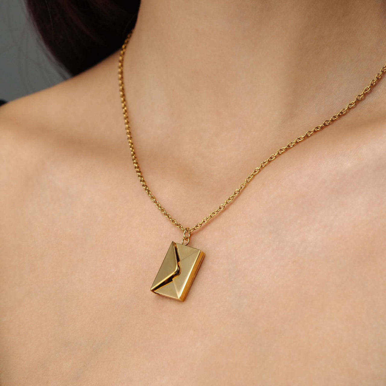 Envelope Name Necklace featuring a gold envelope pendant on a chain by Brother & Sisters.