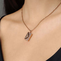 Thumbnail for Envelope Name Necklace by Brother & Sisters showcasing a stylish, personalized design on a model's neck.