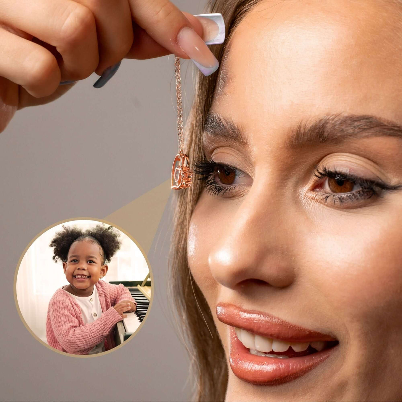 Close-up of woman holding Family Photo Bracelet with a pendant photo of a smiling girl, by Brother & Sisters.