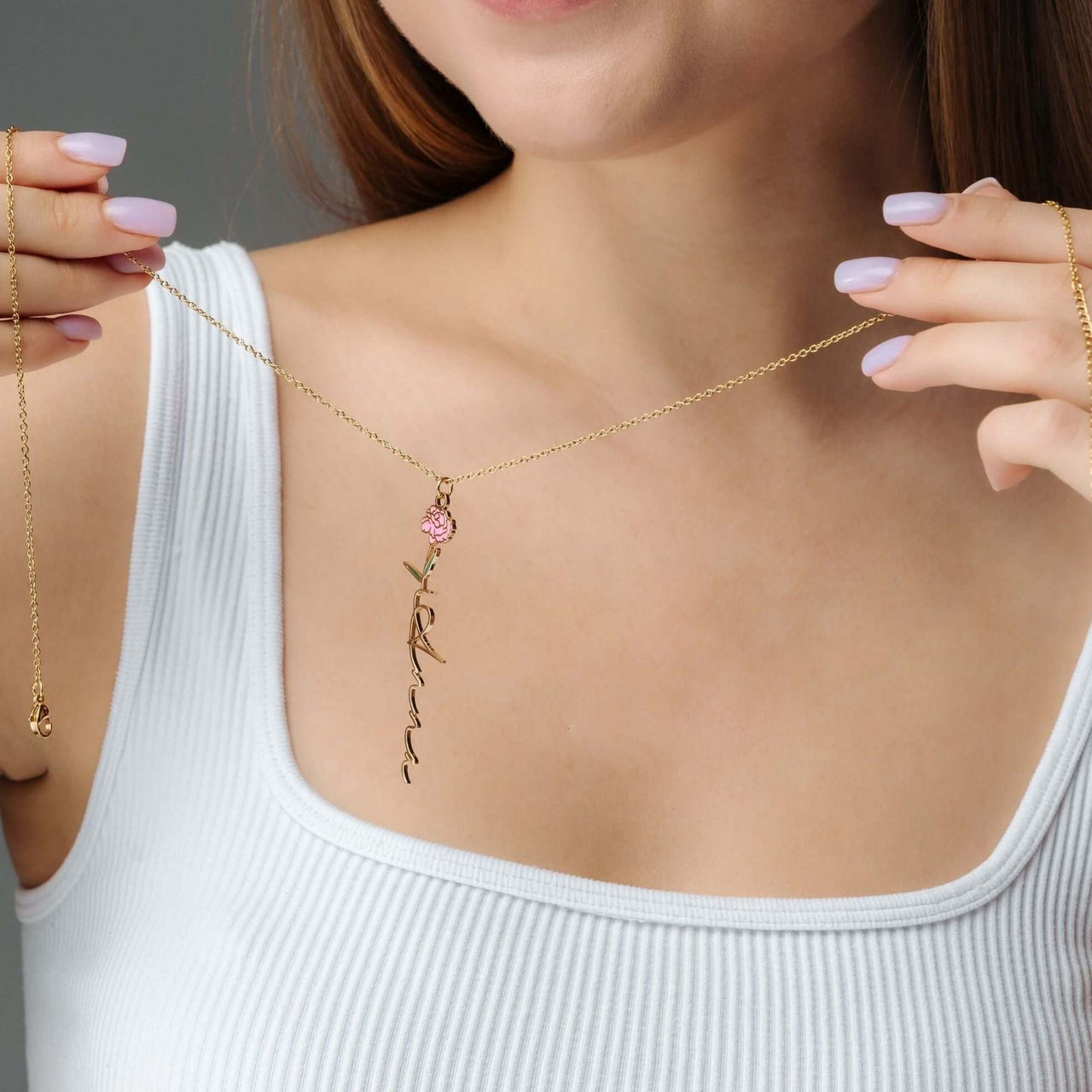 Woman wearing a Flower Name Necklace by Brother & Sisters, featuring a personalized name and floral design.