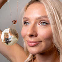 Thumbnail for Woman wearing a Flying Heart Photo Necklace by Brother & Sisters, featuring a personal photo charm.