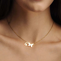 Thumbnail for Butterfly Initial Necklace worn by a woman, featuring a delicate butterfly charm and gold chain, by Brother & Sisters.