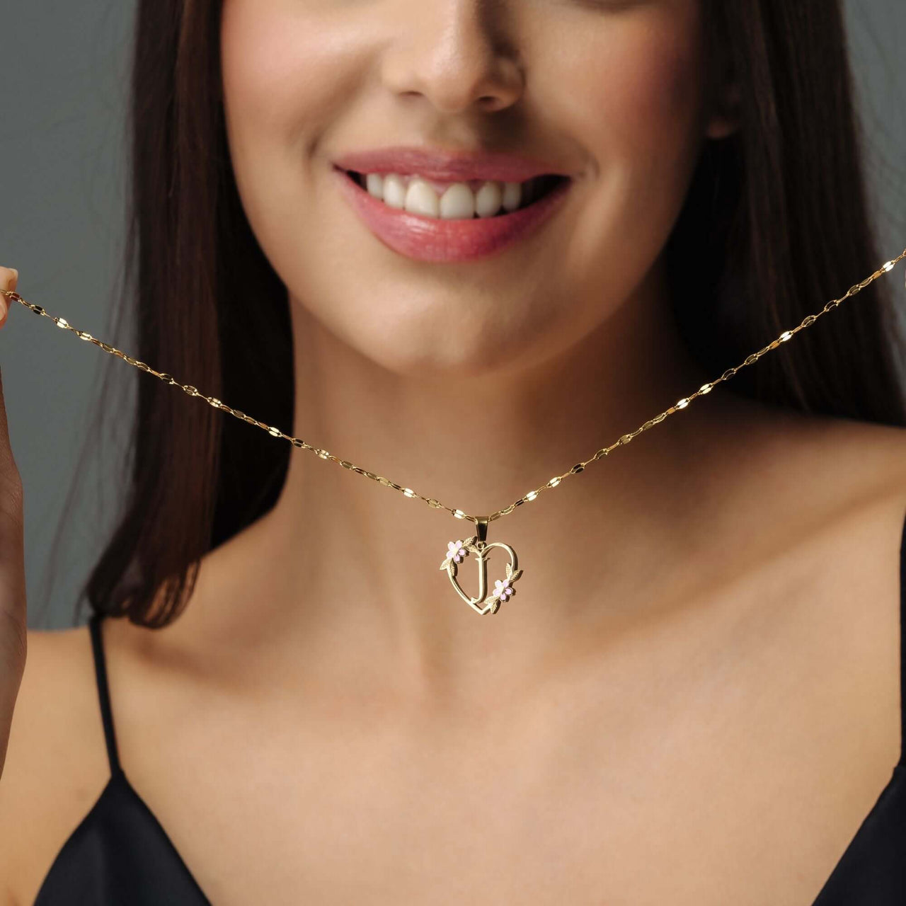 Feminine Initial Necklace worn by a woman, featuring gold heart pendant, designed by Brother & Sisters.