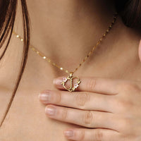 Thumbnail for Feminine Initial Necklace worn by a woman features a gold heart pendant with flowers from Brother & Sisters.