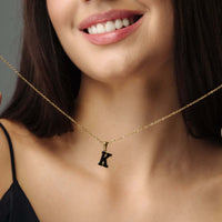 Thumbnail for Hope Initial Necklace worn by a woman, featuring a gold letter 'K' pendant, showcasing elegance by Brother & Sisters.